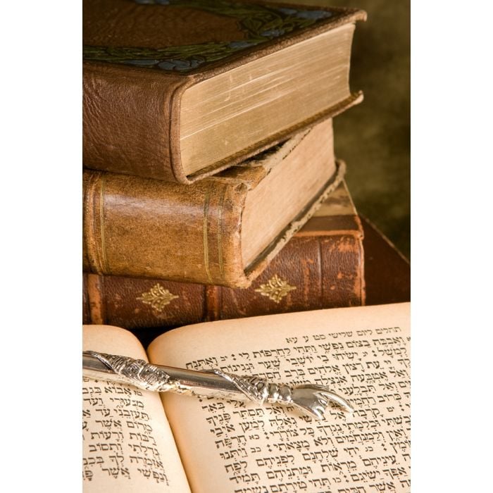 Silver Torah Pointer Lying On A Jewish Prayer Book - ID # 21013351