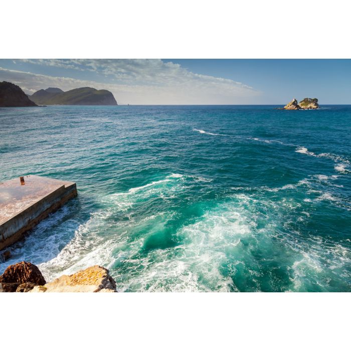 Coastal stones and small pier with breaking waves Adriatic - ID # 166350845