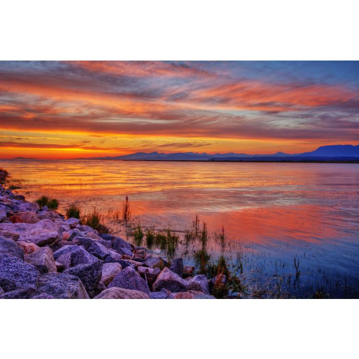 Brilliantly red river sunset with distant mountains - ID # 210305230