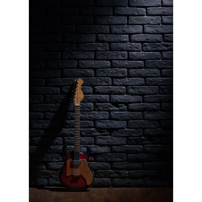 Electric Guitar Leaning On Brick Wall - ID # 247302868