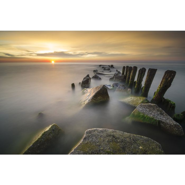 Sunset over the sea blurred long shutter speed breakwaters - ID # 248624641