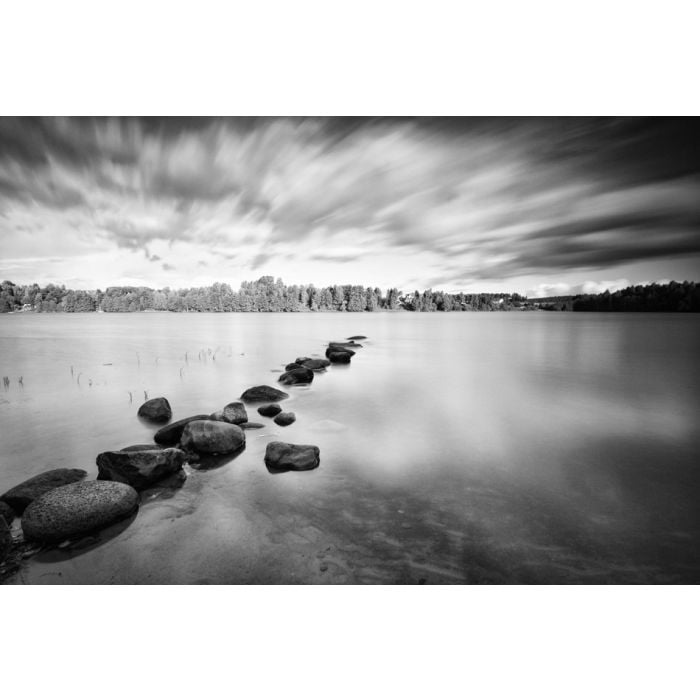 Moving clouds above a tranquil lake in black and white - ID # 38097589