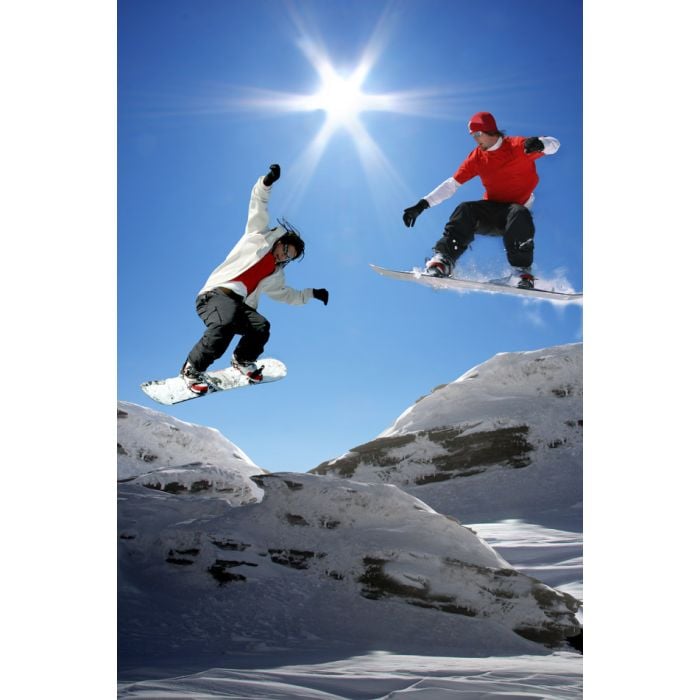 Snowboarders jumping against blue sky - ID # 64067500